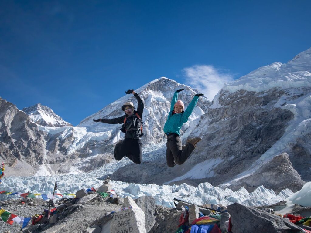 Trekkers Jumping at Everest Base Camp for Photo